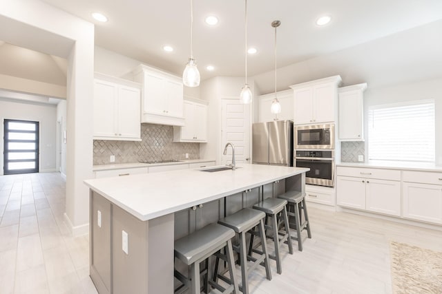 29446 Pearwood Dr, Katy, TX 77494 - kitchen with appliances with stainless steel finishes, a sink, a kitchen island with sink, backsplash, and recessed lighting