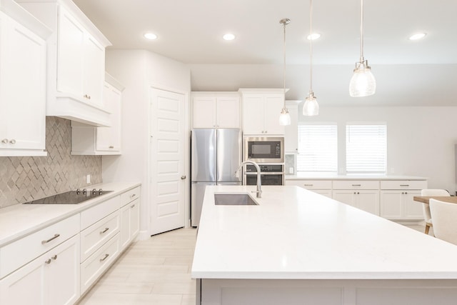 29446 Pearwood Dr, Katy, TX 77494 - kitchen featuring stainless steel appliances, a center island with sink, a sink, light countertops, and decorative backsplash