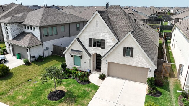 29446 Pearwood Dr, Katy, TX 77494 - french provincial home with a residential view, roof with shingles, driveway, an attached garage, and stone siding