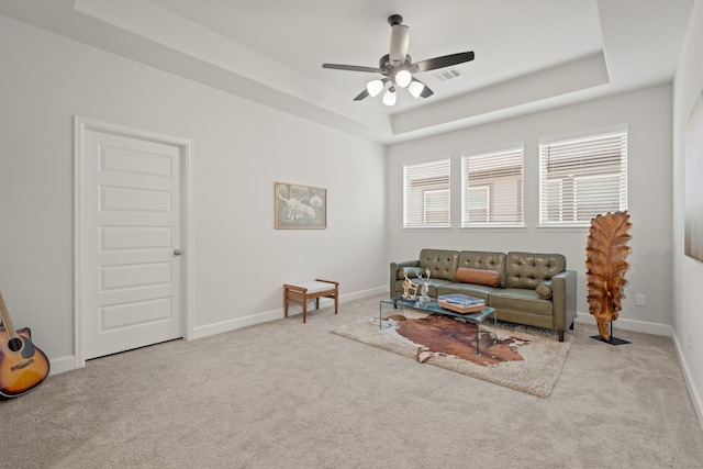 7314 Autumn Sage Dr, Katy, TX 77493 - living room with a raised ceiling, ceiling fan, carpet floors, and baseboards