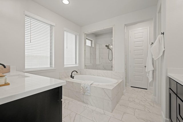 7314 Autumn Sage Dr, Katy, TX 77493 - full bathroom featuring marble look tile flooring, a garden tub, vanity, a shower, and recessed lighting