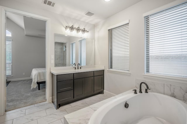 7314 Autumn Sage Dr, Katy, TX 77493 - full bath featuring marble finish floors, plenty of natural light, connected bathroom, and vanity