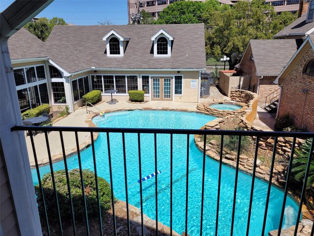 2300 Old Spanish Trl Unit 2136, Houston, TX 77054 - view of pool featuring an in-ground hot tub, a patio, a sunroom, and french doors