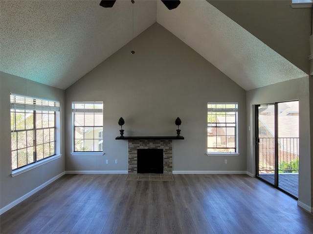 2300 Old Spanish Trl Unit 2136, Houston, TX 77054 - unfurnished living room featuring ceiling fan, high vaulted ceiling, wood finished floors, a textured ceiling, and baseboards