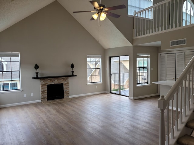 2300 Old Spanish Trl Unit 2136, Houston, TX 77054 - unfurnished living room with high vaulted ceiling, a ceiling fan, wood finished floors, baseboards, and stairway