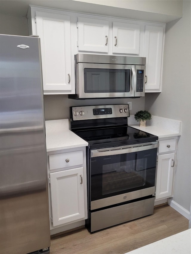 2300 Old Spanish Trl Unit 2136, Houston, TX 77054 - kitchen with stainless steel appliances, light wood-style floors, light countertops, and white cabinets