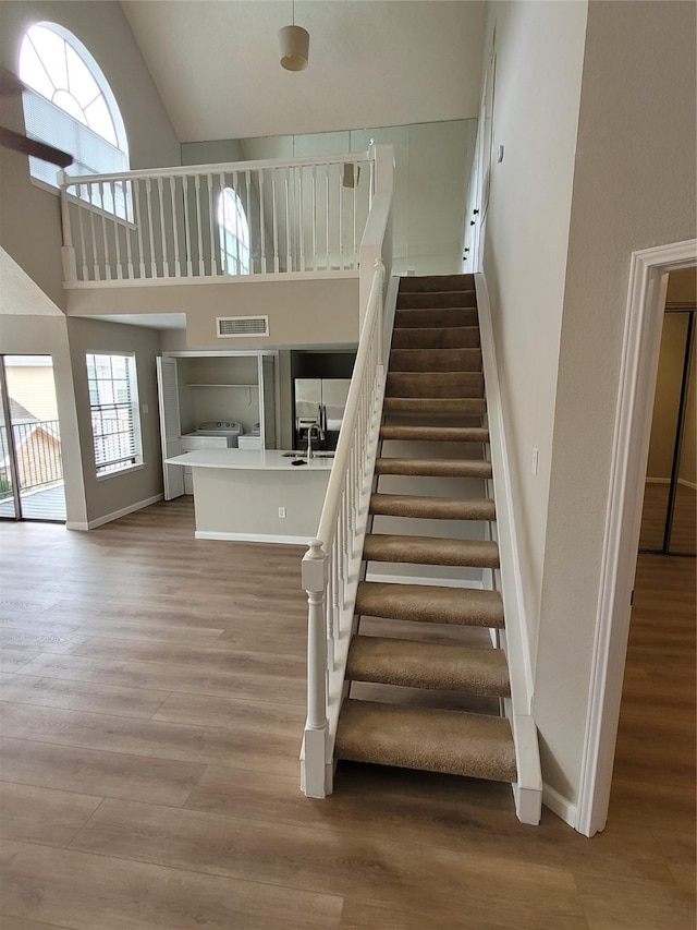 2300 Old Spanish Trl Unit 2136, Houston, TX 77054 - stairway with wood finished floors, baseboards, and high vaulted ceiling