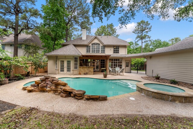 37 S Piney Plains Cir, The Woodlands, TX 77382 - rear view of property featuring french doors, a patio area, a chimney, and fence