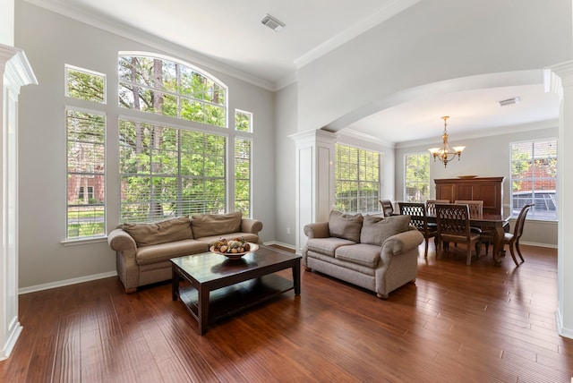 37 S Piney Plains Cir, The Woodlands, TX 77382 - living area with a chandelier, arched walkways, decorative columns, dark wood-style floors, and ornamental molding