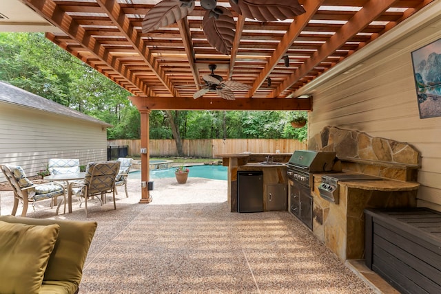 37 S Piney Plains Cir, The Woodlands, TX 77382 - view of patio featuring area for grilling, exterior kitchen, a ceiling fan, a fenced backyard, and a pergola