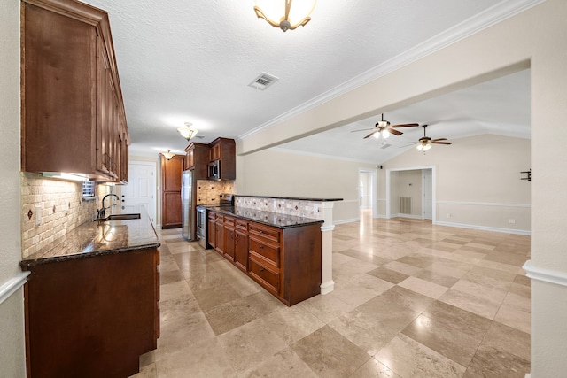 11243 Rousseau Dr, Houston, TX 77065 - kitchen featuring appliances with stainless steel finishes, tasteful backsplash, a sink, ceiling fan, and dark stone counters