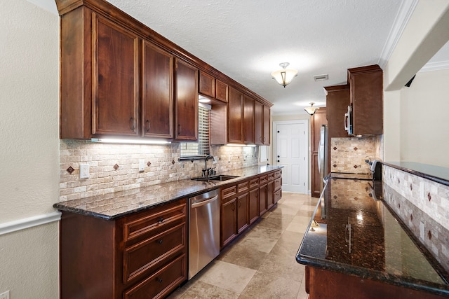 11243 Rousseau Dr, Houston, TX 77065 - kitchen featuring stainless steel appliances, a sink, ornamental molding, decorative backsplash, and dark stone countertops