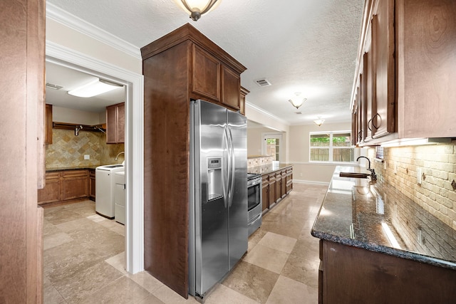 11243 Rousseau Dr, Houston, TX 77065 - kitchen featuring appliances with stainless steel finishes, independent washer and dryer, backsplash, a sink, and ornamental molding