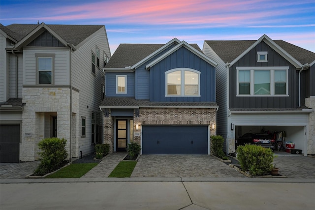 10964 Swang Link Dr, Houston, TX 77043 - view of property with board and batten siding, an attached garage, driveway, roof with shingles, and stone siding