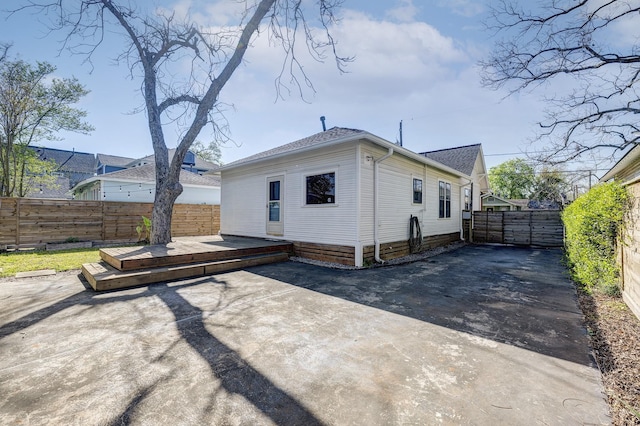 1016 Louise St, Houston, TX 77009 - rear view of house with a fenced backyard, a deck, a patio area, and roof with shingles
