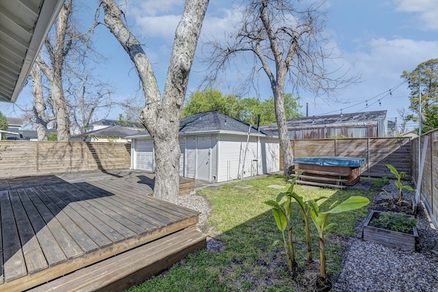 1016 Louise St, Houston, TX 77009 - view of yard featuring a deck, a hot tub, an outdoor structure, and a detached garage