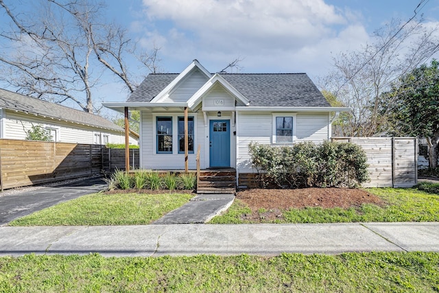 1016 Louise St, Houston, TX 77009 - bungalow with covered porch, roof with shingles, and fence