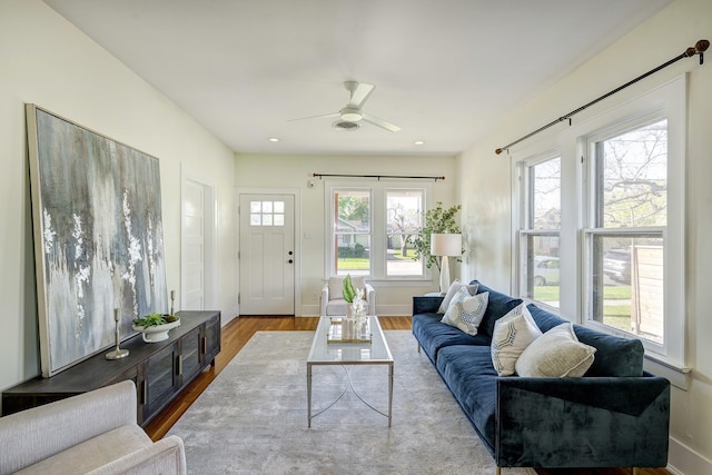 1016 Louise St, Houston, TX 77009 - living room featuring a ceiling fan, wood finished floors, and baseboards