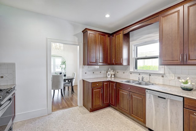 1016 Louise St, Houston, TX 77009 - kitchen with appliances with stainless steel finishes, a sink, tasteful backsplash, light stone countertops, and recessed lighting