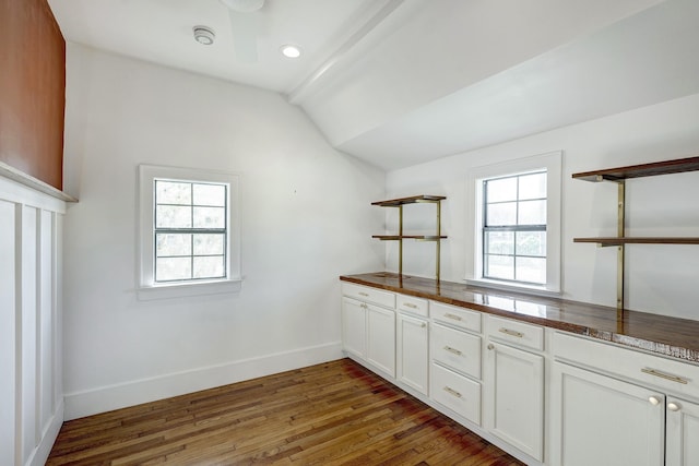 1016 Louise St, Houston, TX 77009 - kitchen featuring open shelves, vaulted ceiling, wood finished floors, baseboards, and dark countertops