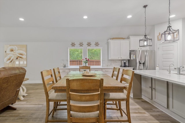 dining area featuring light wood-style floors and recessed lighting