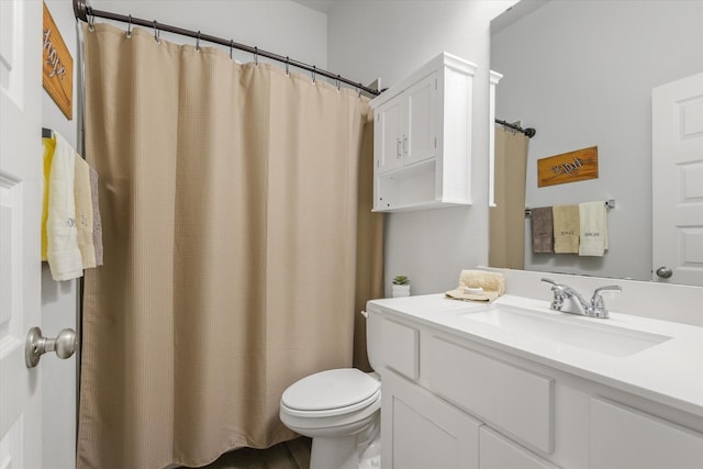 full bath featuring vanity and toilet