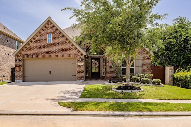 view of front of property with brick siding, driveway, and an attached garage