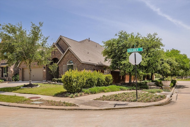 view of front of house featuring brick siding, concrete driveway, a garage, and fence