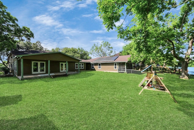 5103 Diamond Springs Dr, Missouri City, TX 77459 - view of green lawn with french doors, a playground, and a sunroom