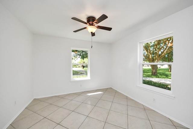 5103 Diamond Springs Dr, Missouri City, TX 77459 - empty room with plenty of natural light, a ceiling fan, light tile patterned floors, and baseboards
