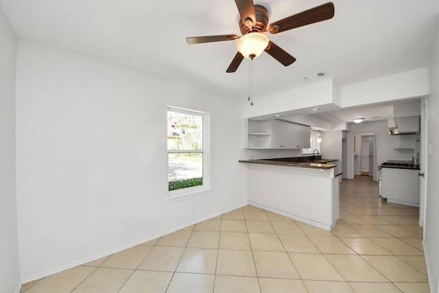 5103 Diamond Springs Dr, Missouri City, TX 77459 - kitchen featuring open shelves, dark countertops, a peninsula, and white cabinetry