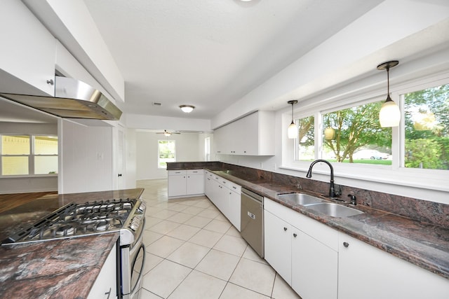 5103 Diamond Springs Dr, Missouri City, TX 77459 - kitchen with appliances with stainless steel finishes, a sink, light tile patterned floors, white cabinets, and pendant lighting