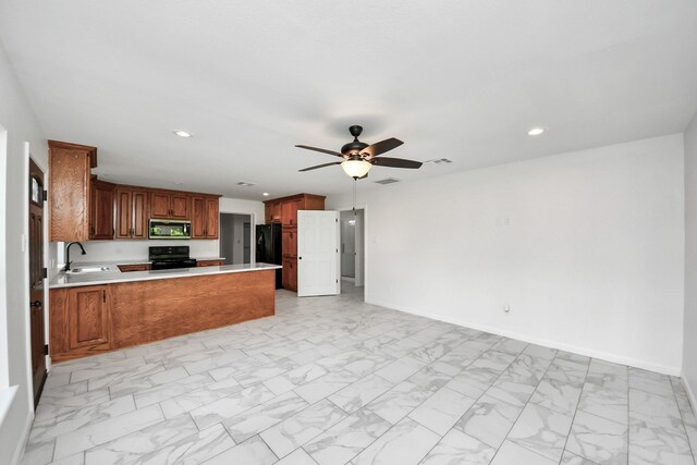 5103 Diamond Springs Dr, Missouri City, TX 77459 - kitchen featuring black appliances, open floor plan, light marble finish floors, a sink, and a peninsula