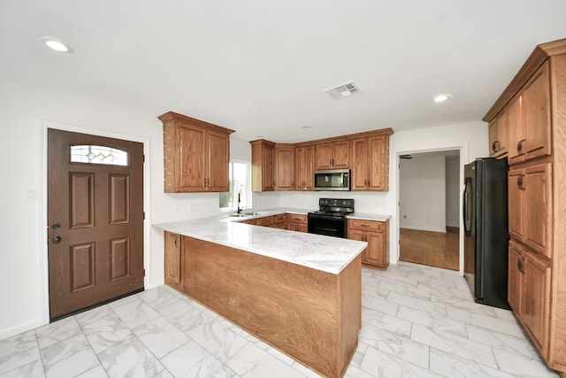 5103 Diamond Springs Dr, Missouri City, TX 77459 - kitchen featuring black appliances, a peninsula, light marble finish floors, a sink, and recessed lighting