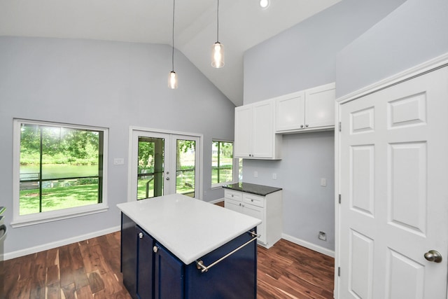 5103 Diamond Springs Dr, Missouri City, TX 77459 - kitchen with blue cabinetry, high vaulted ceiling, white cabinets, a center island, and hanging light fixtures
