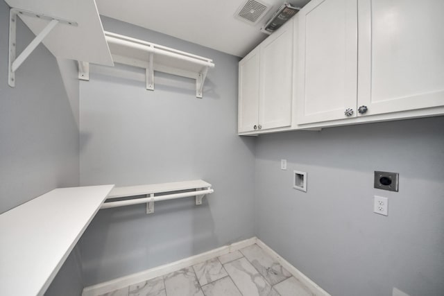 5103 Diamond Springs Dr, Missouri City, TX 77459 - clothes washing area with electric dryer hookup, cabinet space, washer hookup, light marble finish flooring, and baseboards