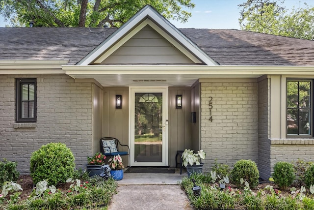 2514 Briarbrook Dr, Houston, TX 77042 - doorway to property featuring roof with shingles and brick siding