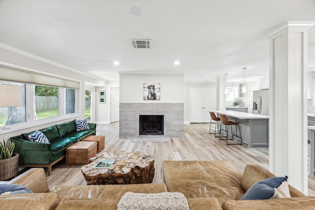 2514 Briarbrook Dr, Houston, TX 77042 - living area with crown molding, light wood-type flooring, a premium fireplace, recessed lighting, and baseboards