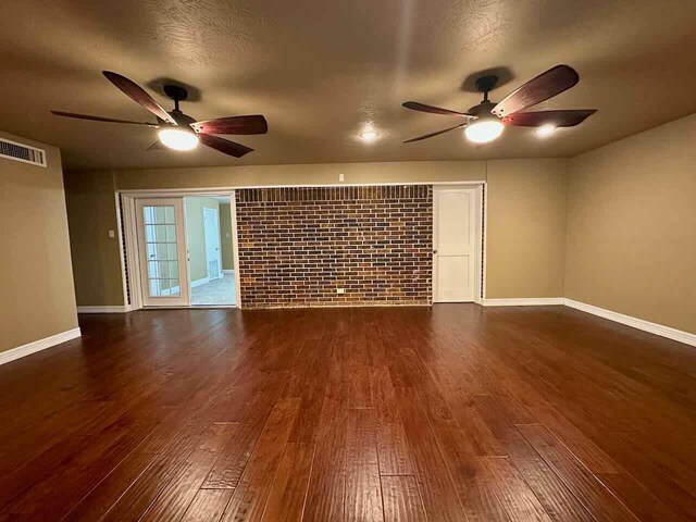 207 Lucky Dr, Silsbee, TX 77656 - empty room featuring a ceiling fan, dark wood-style floors, and baseboards