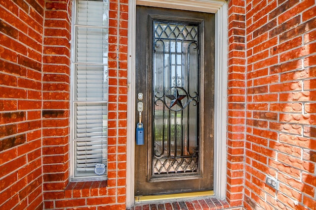 11707 Turtle Lake Dr, Houston, TX 77064 - view of exterior entry featuring brick siding