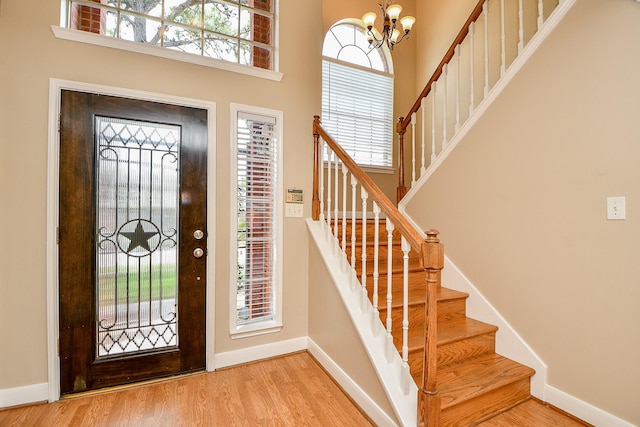 11707 Turtle Lake Dr, Houston, TX 77064 - entryway with a chandelier, baseboards, healthy amount of natural light, and a towering ceiling