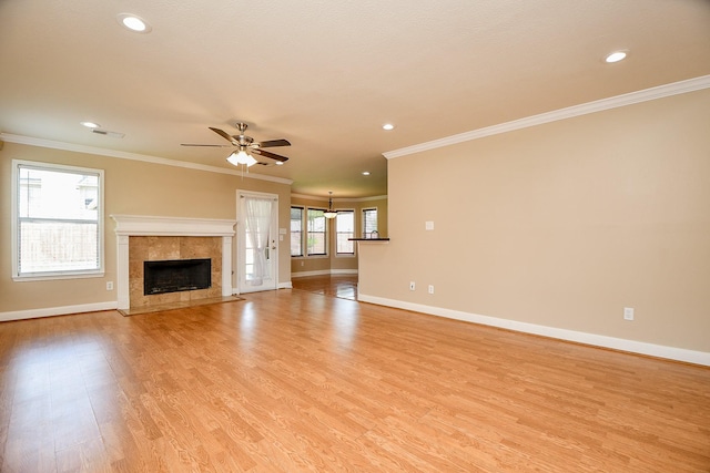 11707 Turtle Lake Dr, Houston, TX 77064 - unfurnished living room with baseboards, ceiling fan, crown molding, light wood-style floors, and a tiled fireplace