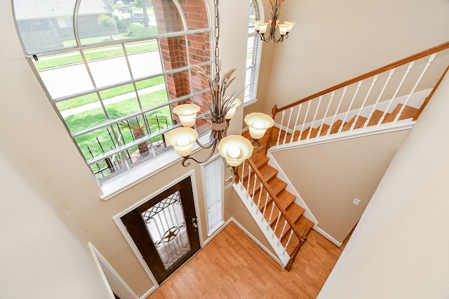 11707 Turtle Lake Dr, Houston, TX 77064 - foyer featuring a chandelier, a high ceiling, stairway, light wood-style flooring, and healthy amount of natural light