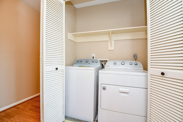 11707 Turtle Lake Dr, Houston, TX 77064 - laundry area featuring independent washer and dryer, light wood finished floors, and baseboards