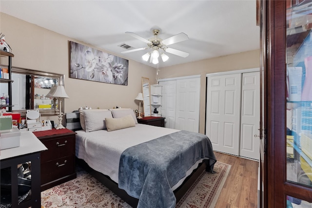 12574 Newbrook Dr, Houston, TX 77072 - bedroom with two closets, light wood-style flooring, and a ceiling fan