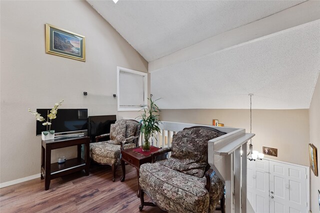 12574 Newbrook Dr, Houston, TX 77072 - living area with lofted ceiling, wood finished floors, and baseboards