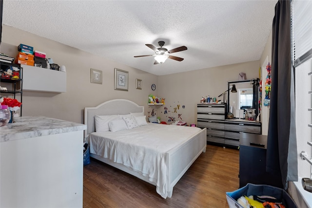 12574 Newbrook Dr, Houston, TX 77072 - bedroom featuring wood finished floors, a textured ceiling, and a ceiling fan