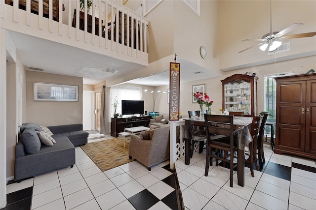 12574 Newbrook Dr, Houston, TX 77072 - living area featuring ceiling fan, plenty of natural light, light tile patterned floors, and a towering ceiling