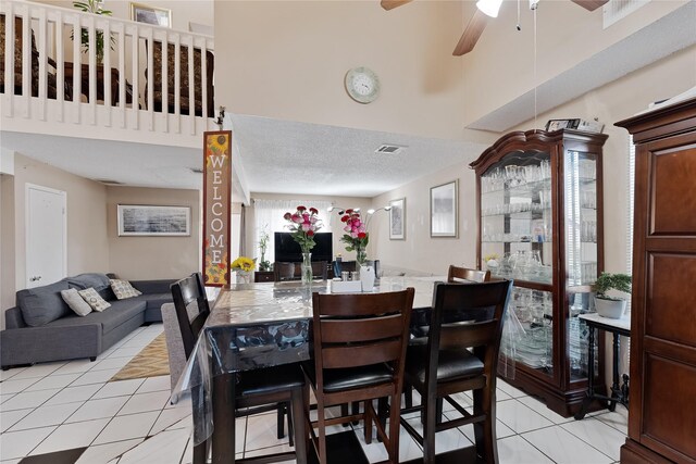 12574 Newbrook Dr, Houston, TX 77072 - dining room featuring light tile patterned flooring, a ceiling fan, and a towering ceiling