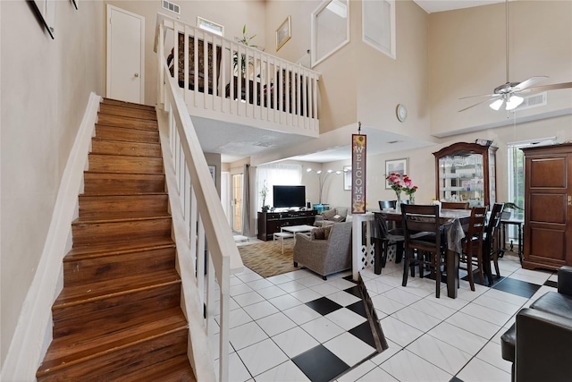 12574 Newbrook Dr, Houston, TX 77072 - staircase with a ceiling fan, a high ceiling, and tile patterned floors